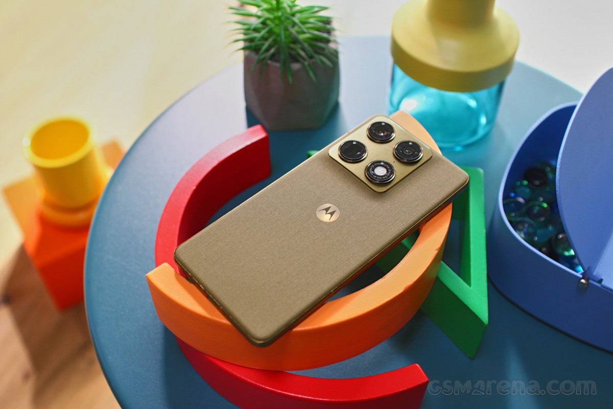 CDATA[Motorola stays true to its design language with the Signature model, offering a distinct look that sets it apart from the Moto G series. The camera island is a standout feature—it's an actual island, not extending down the back, with chamfered edges and color accents. The camera rings are accented, matching the island plate, which on the Martini Olive unit resembles a golden/green brushed metal.
![Motorola Signature review