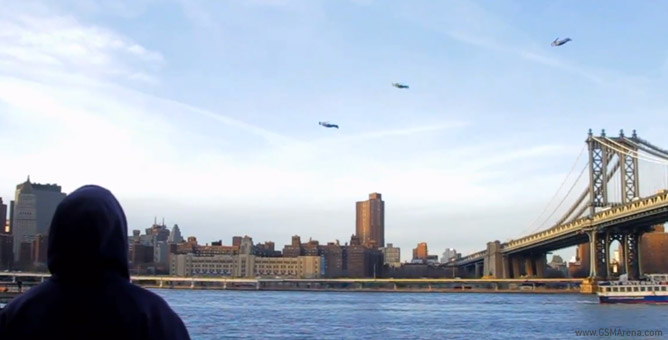 An onlooker watches the three mysterious figures fly around New York