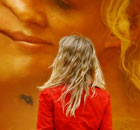 A woman is reflected in one of Anish Kapoor's stainless-steel sculptures